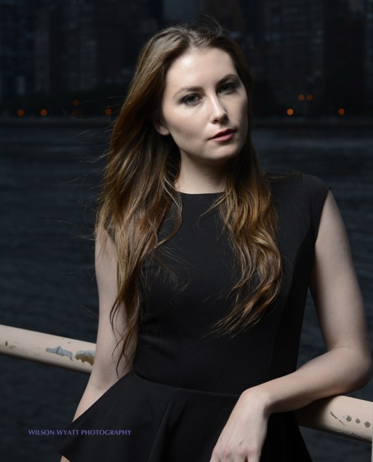 Outdoor portrait of professional model Nastasia at night against the Manhattan skyline, taken on Roosevelt Island.
